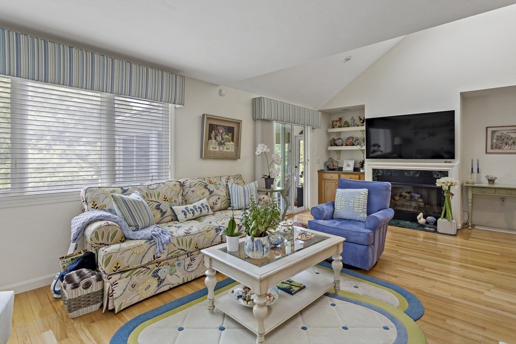 8 Chippers Lane, Unit 390 Mashpee, MA 02649 - Photo 9 of 38 a living room with furniture and a flat screen tv
