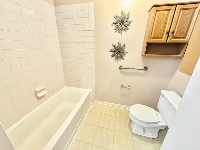 a bathroom with a bathtub and toilet