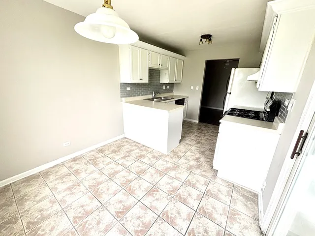 a kitchen with a sink appliances and cabinets
