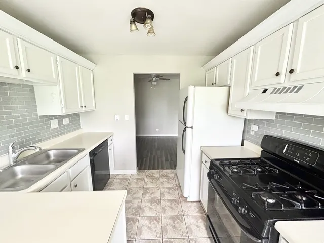 a kitchen with a refrigerator and a sink