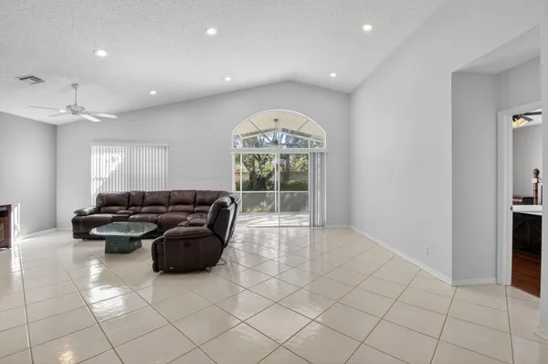 a living room with furniture and kitchen view