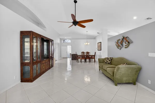a living room with furniture and kitchen view