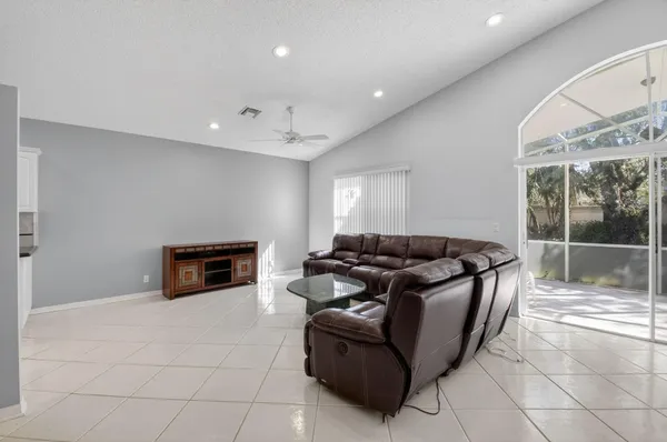 a kitchen with white cabinets and refrigerator