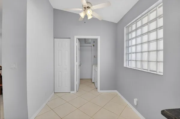 a bedroom with a bed and a dresser with the wooden floor