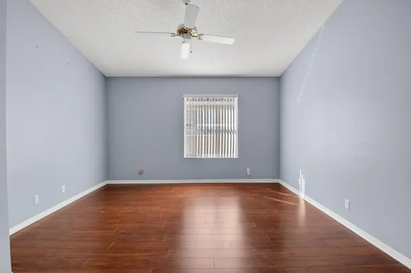 a bathroom with a granite countertop sink a mirror and a bathtub