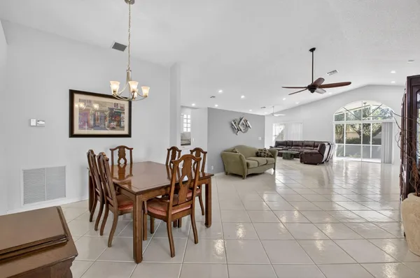 a lobby with furniture and a ceiling fan