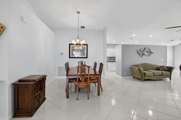 a dining room with furniture and chandelier
