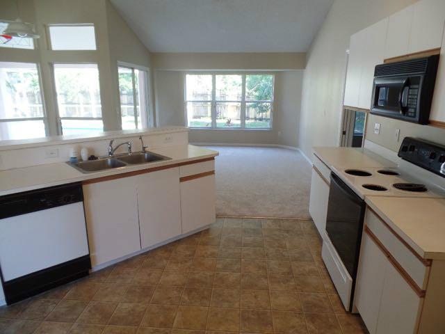 1234 Southwest Chase Road Port St. Lucie, FL 34953 - Photo 7 of 20 a kitchen that has a sink and a stove in it