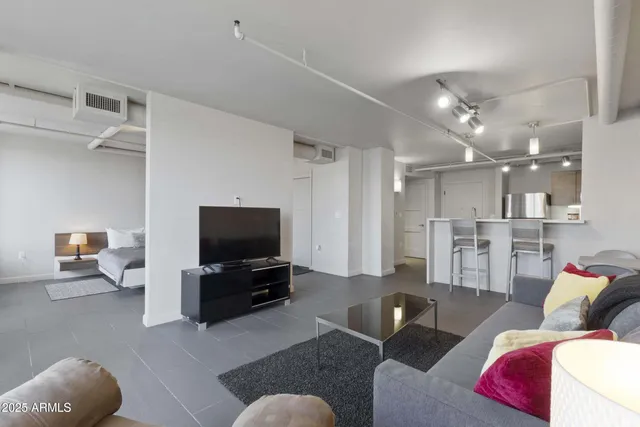 a living room with furniture and a flat screen tv