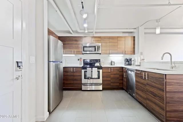 a kitchen with cabinets oven and a sink