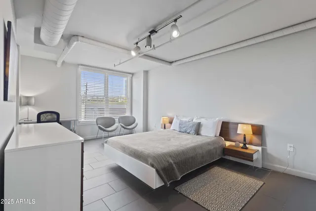 a bedroom with a bed and window