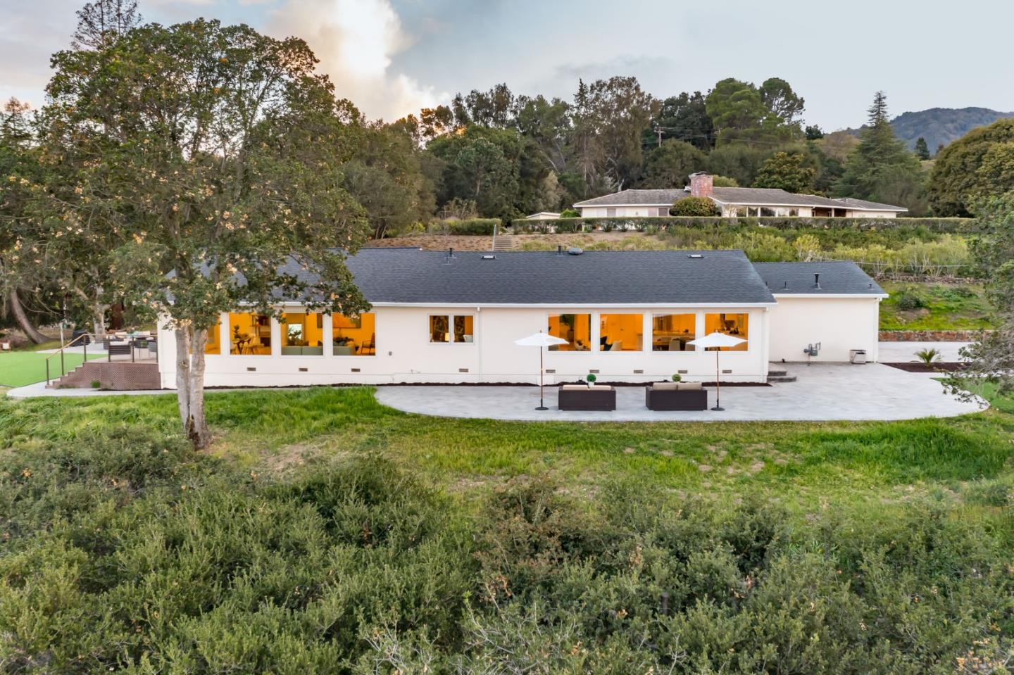 an aerial view of a house with swimming pool garden and patio