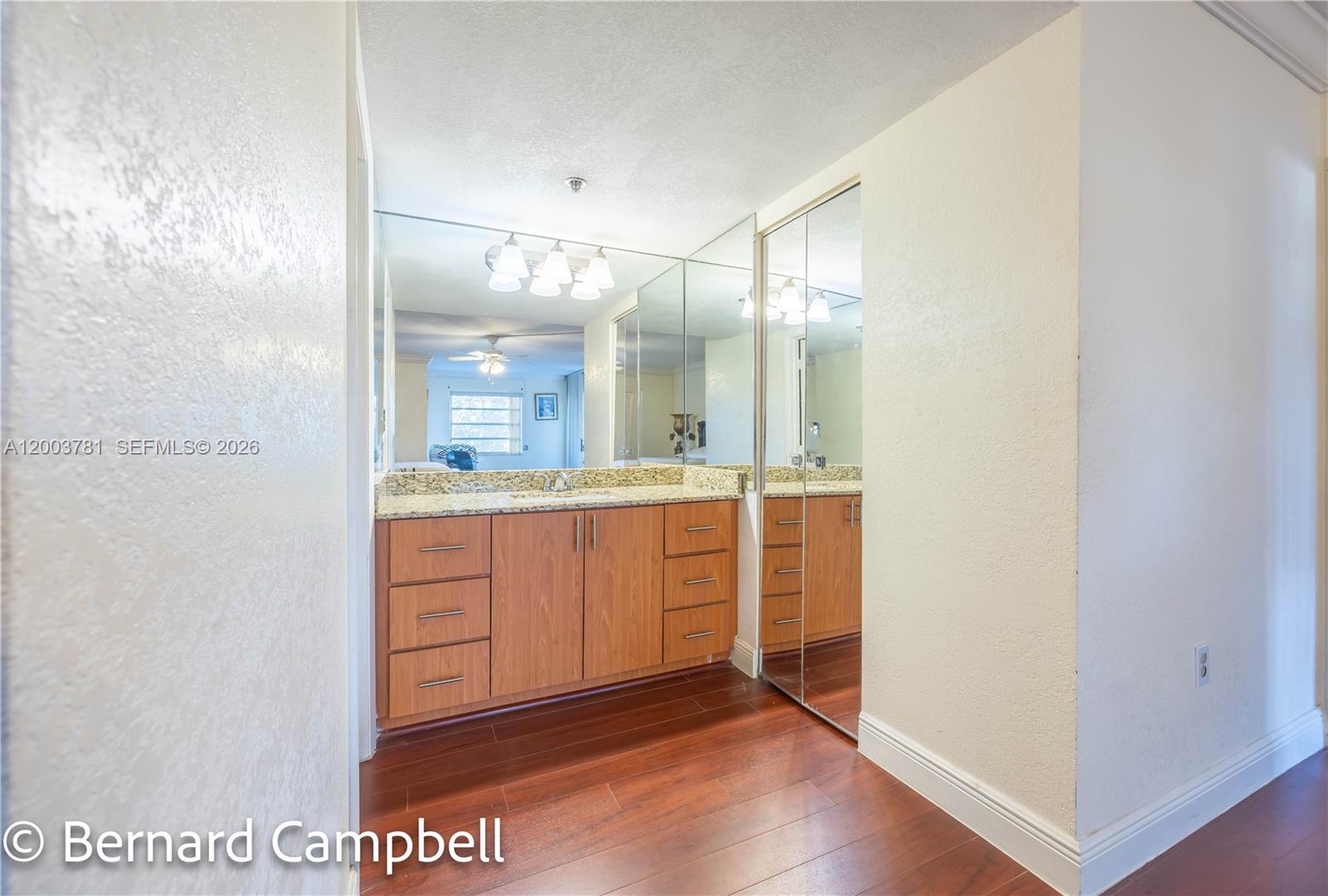 3940 Inverrary Boulevard, Unit 403A Lauderhill, FL 33319 - Photo 12 of 37 a bathroom with a glass door shower a sink and a mirror