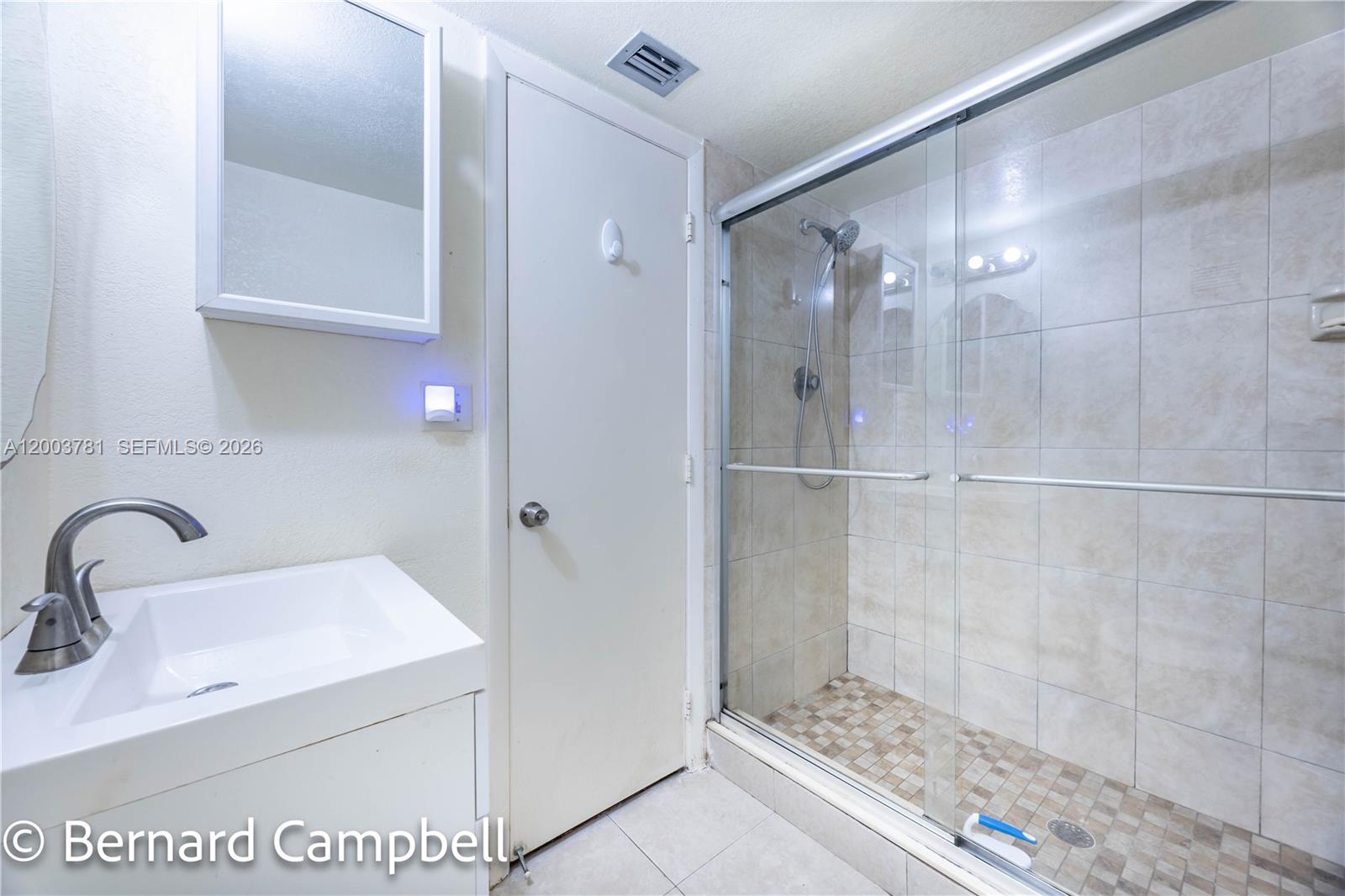 3940 Inverrary Boulevard, Unit 403A Lauderhill, FL 33319 - Photo 13 of 37 a bathroom with a sink and a mirror