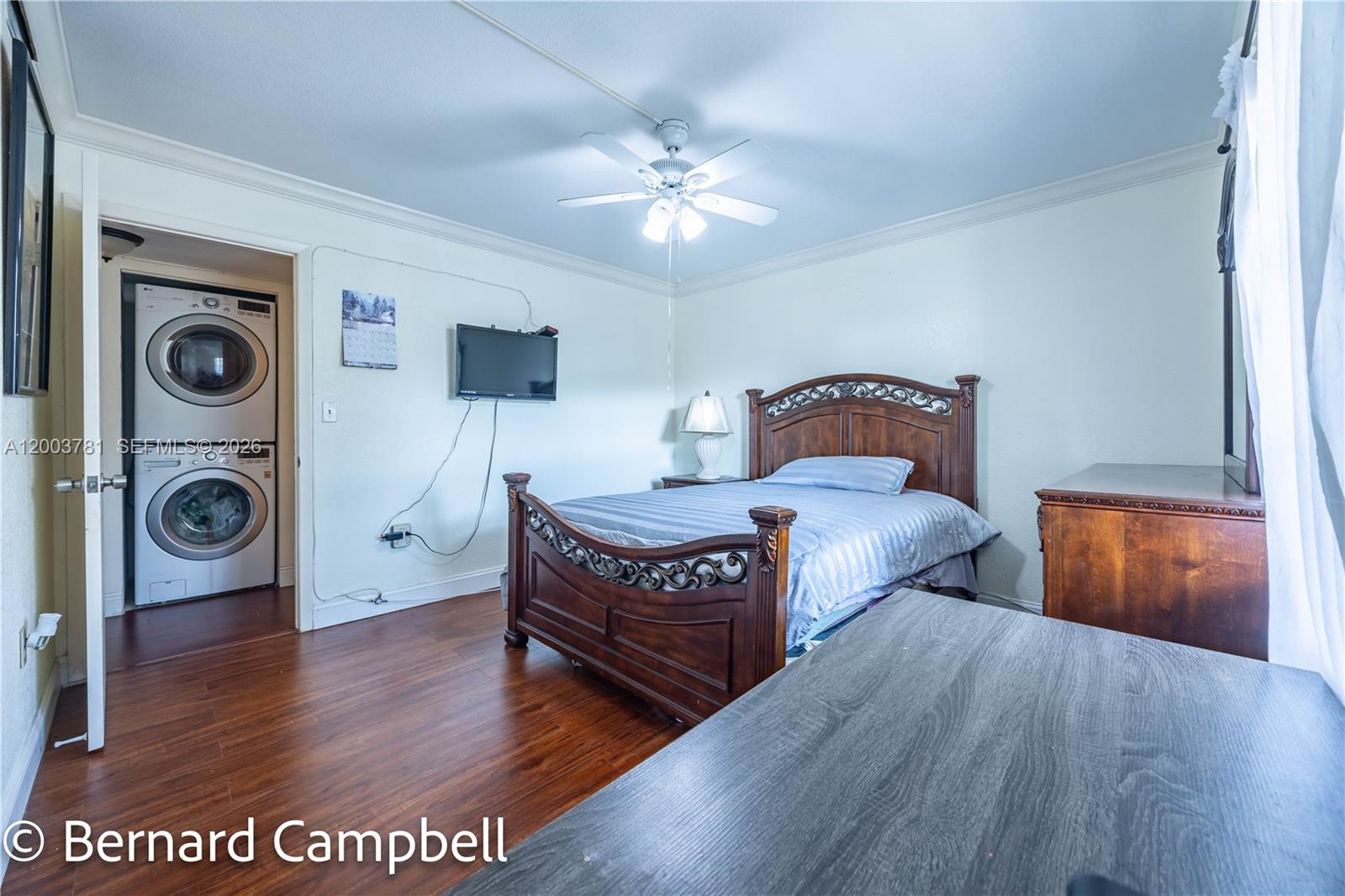 3940 Inverrary Boulevard, Unit 403A Lauderhill, FL 33319 - Photo 17 of 37 a bedroom with a bed and wooden floor