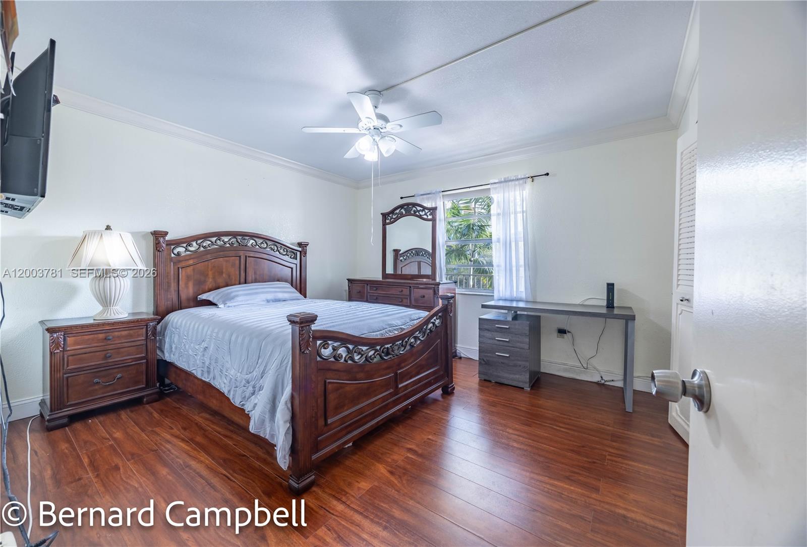 3940 Inverrary Boulevard, Unit 403A Lauderhill, FL 33319 - Photo 18 of 37 a bedroom with a bed and wooden floor