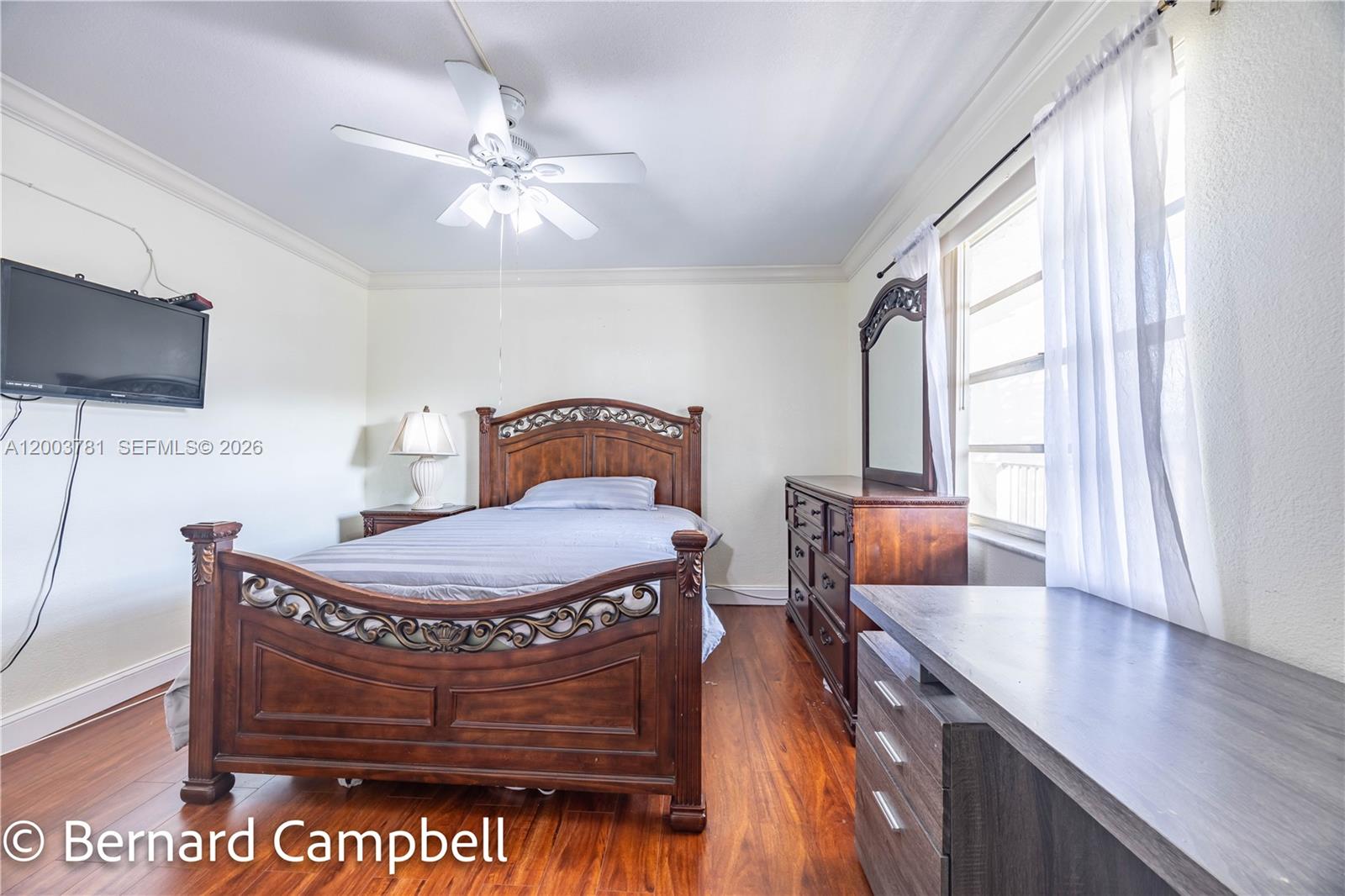 3940 Inverrary Boulevard, Unit 403A Lauderhill, FL 33319 - Photo 19 of 37 a living room with furniture a flat screen tv and a large window