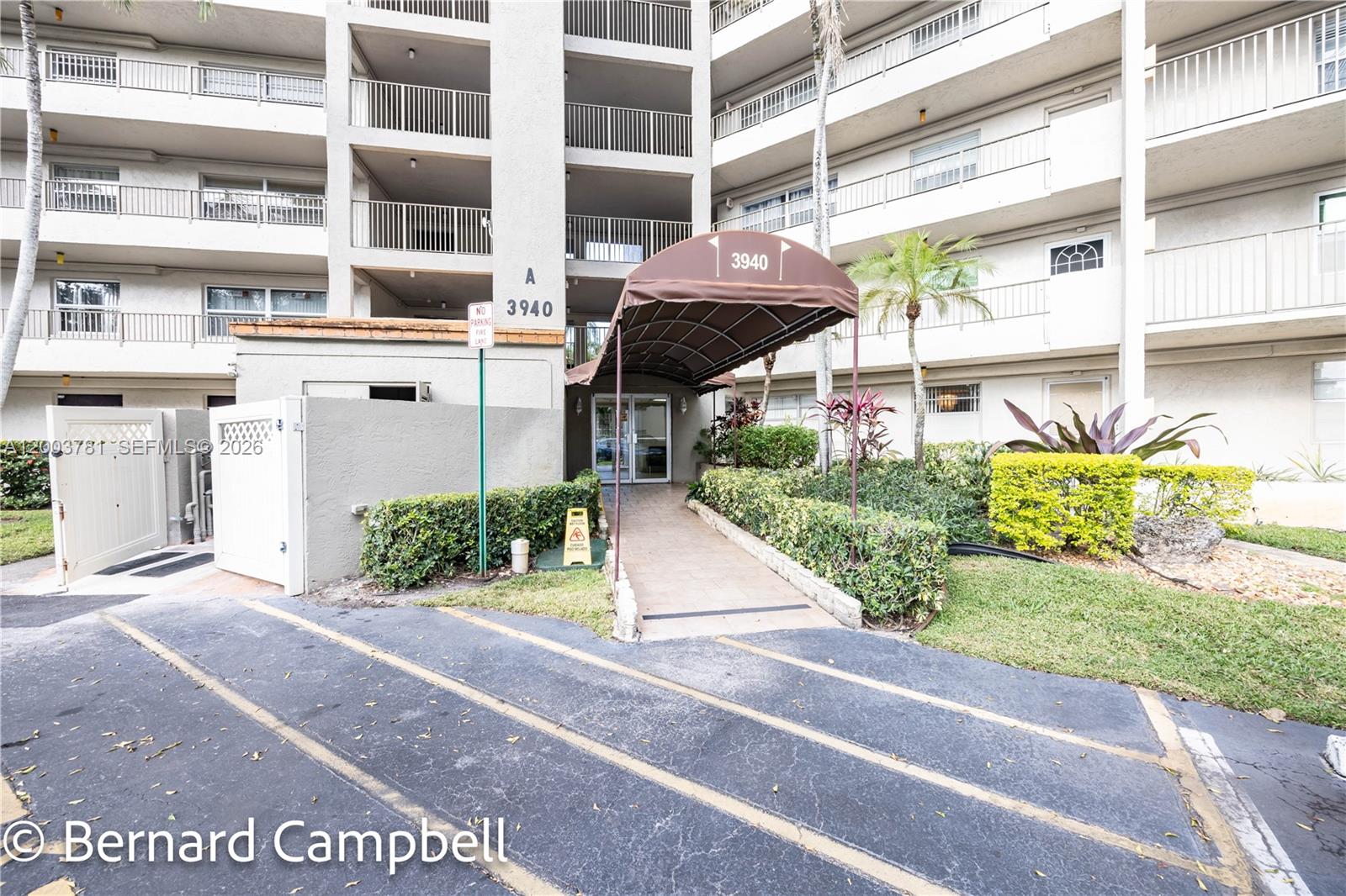 3940 Inverrary Boulevard, Unit 403A Lauderhill, FL 33319 - Photo 29 of 37 a front view of a building with a garden
