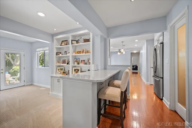 a dining room with furniture and a large window