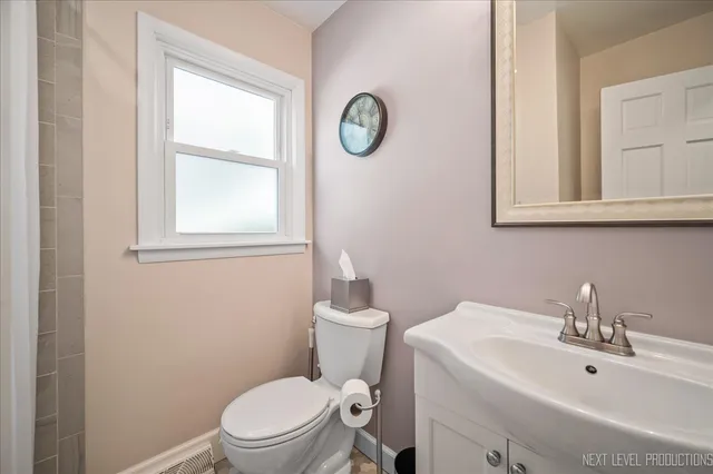 a bathroom with a sink a toilet and a mirror