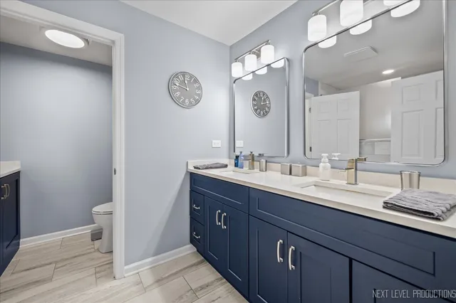 a bathroom with a double vanity sink and a mirror