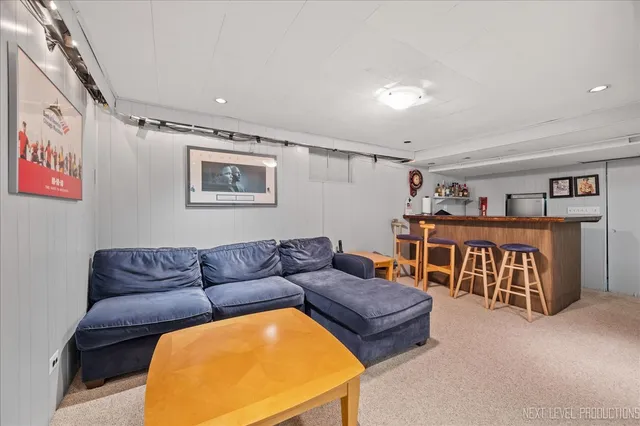a living room with furniture gym equipment and a rug