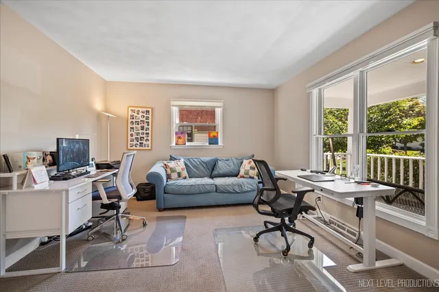 a livingroom with workspace and a window