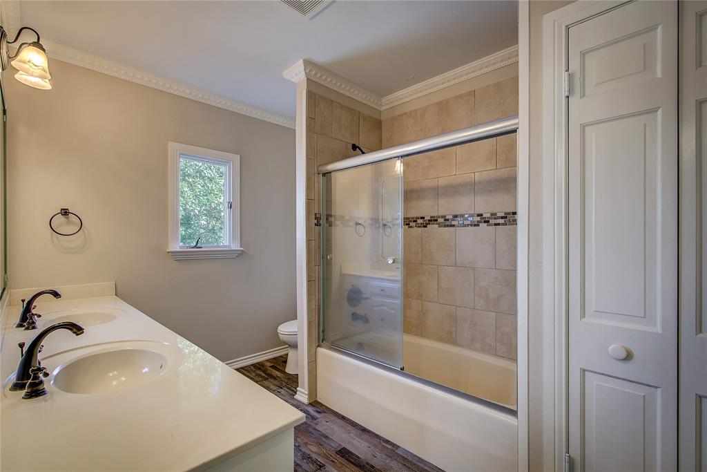7359 Highway 154 Sulphur Springs, TX 75482 - Photo 29 of 40 upstairs- hall bathroom (bath 3), double vanity, tub/shower combo with glass door, linen closet
