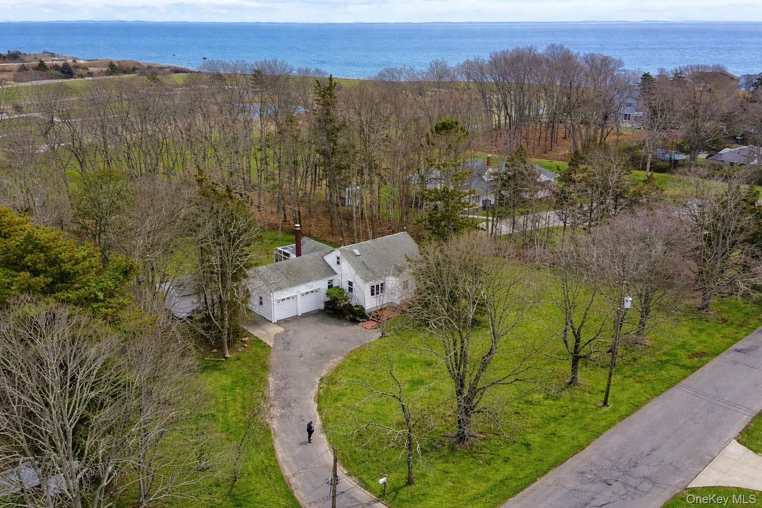 281 Woodacres Road East Patchogue, NY 11772 - Photo 1 of 11 View of Great South Bay, Bellport Golf Course, and of the front of the home.Green Grass Courtesy of AI.