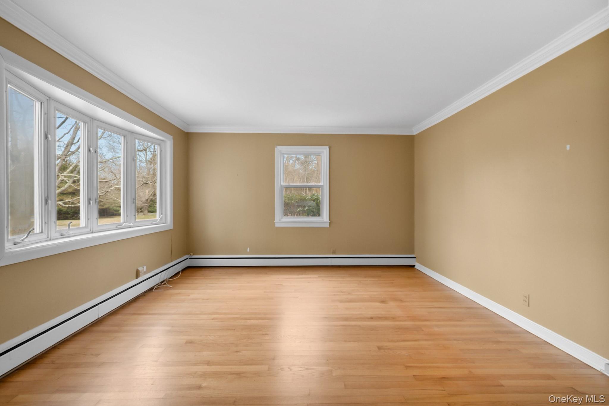 281 Woodacres Road East Patchogue, NY 11772 - Photo 7 of 11 Sunny living room with wood floors