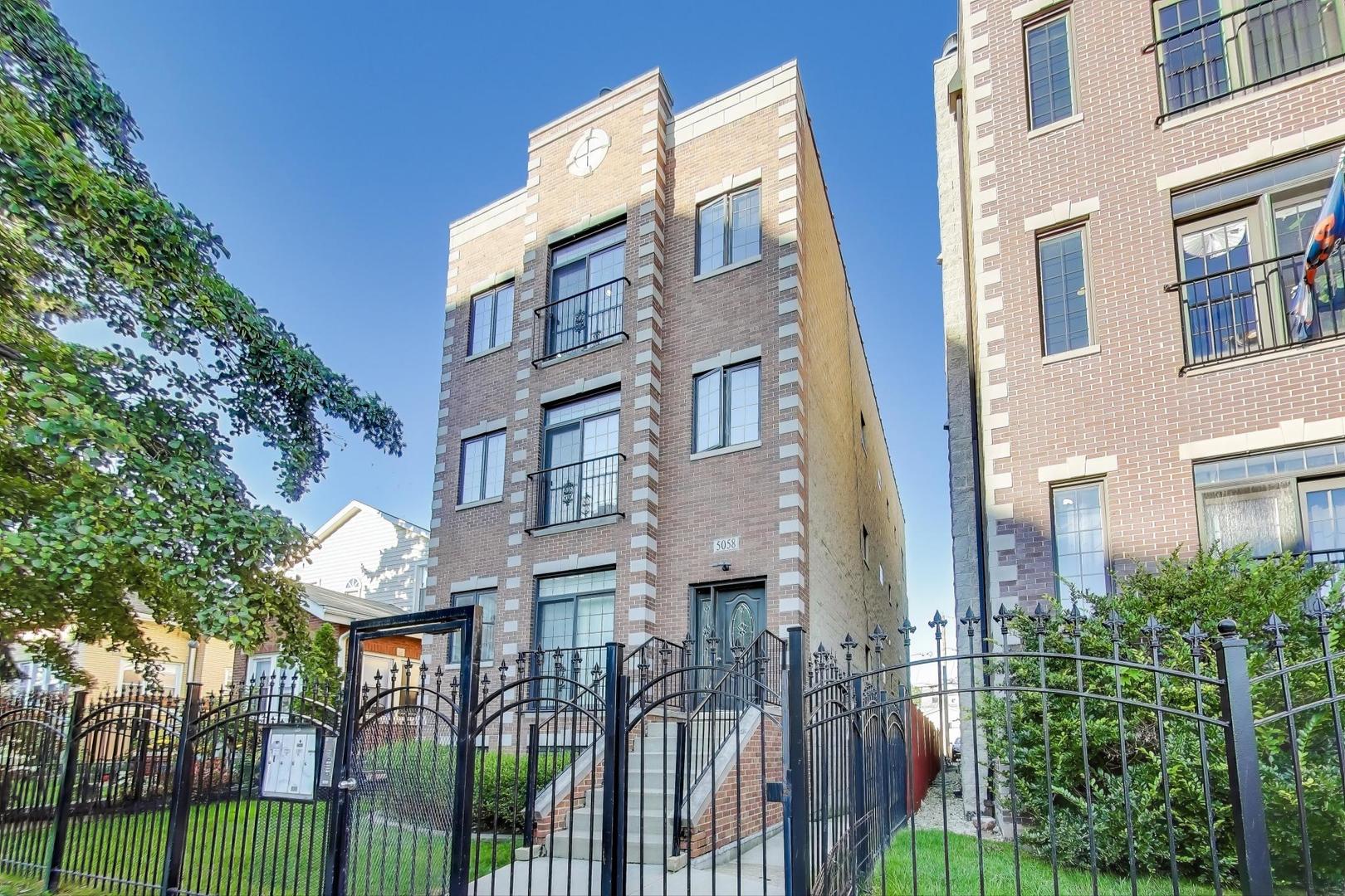 a view of a brick building next to a yard