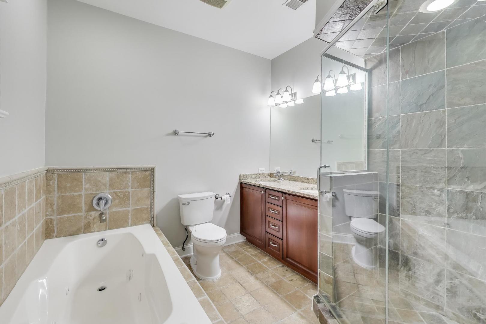 5058 North Kimball Avenue, Unit 4 Chicago, IL 60625 - Photo 16 of 26 a bathroom with a sink a toilet and shower