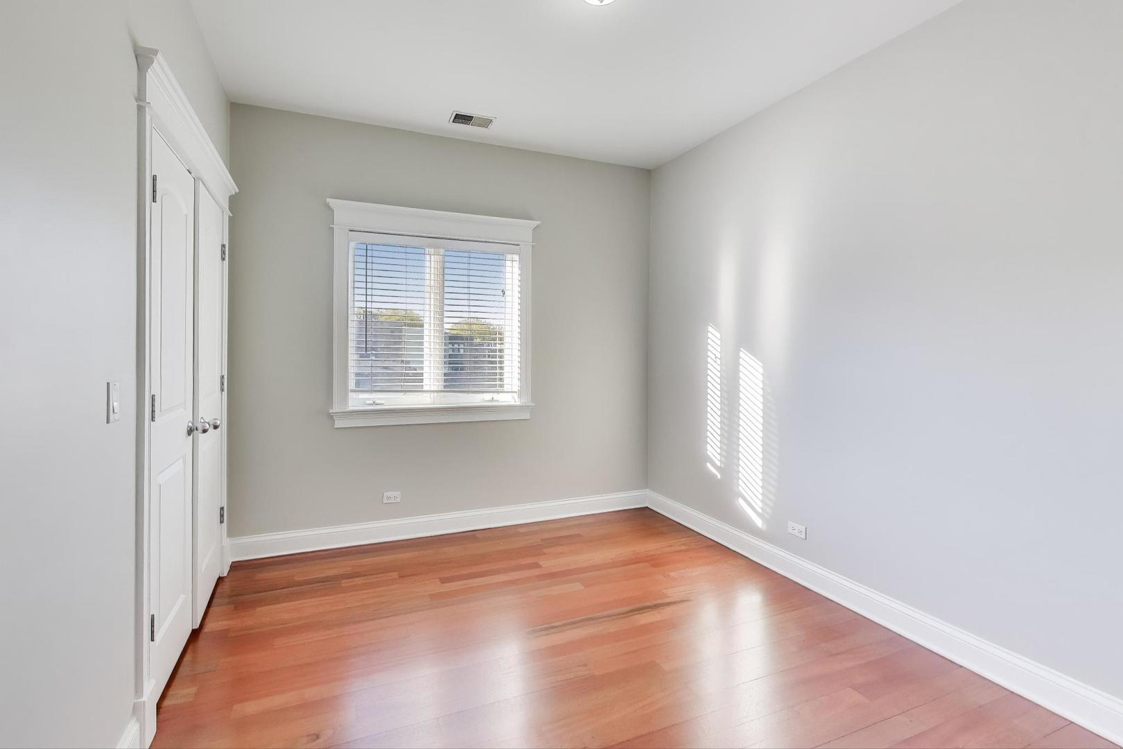5058 North Kimball Avenue, Unit 4 Chicago, IL 60625 - Photo 21 of 26 a view of empty room with wooden floor and fan