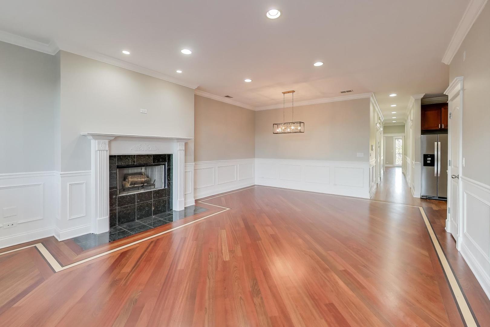 5058 North Kimball Avenue, Unit 4 Chicago, IL 60625 - Photo 3 of 26 a view of a hallway with wooden floor and a fireplace