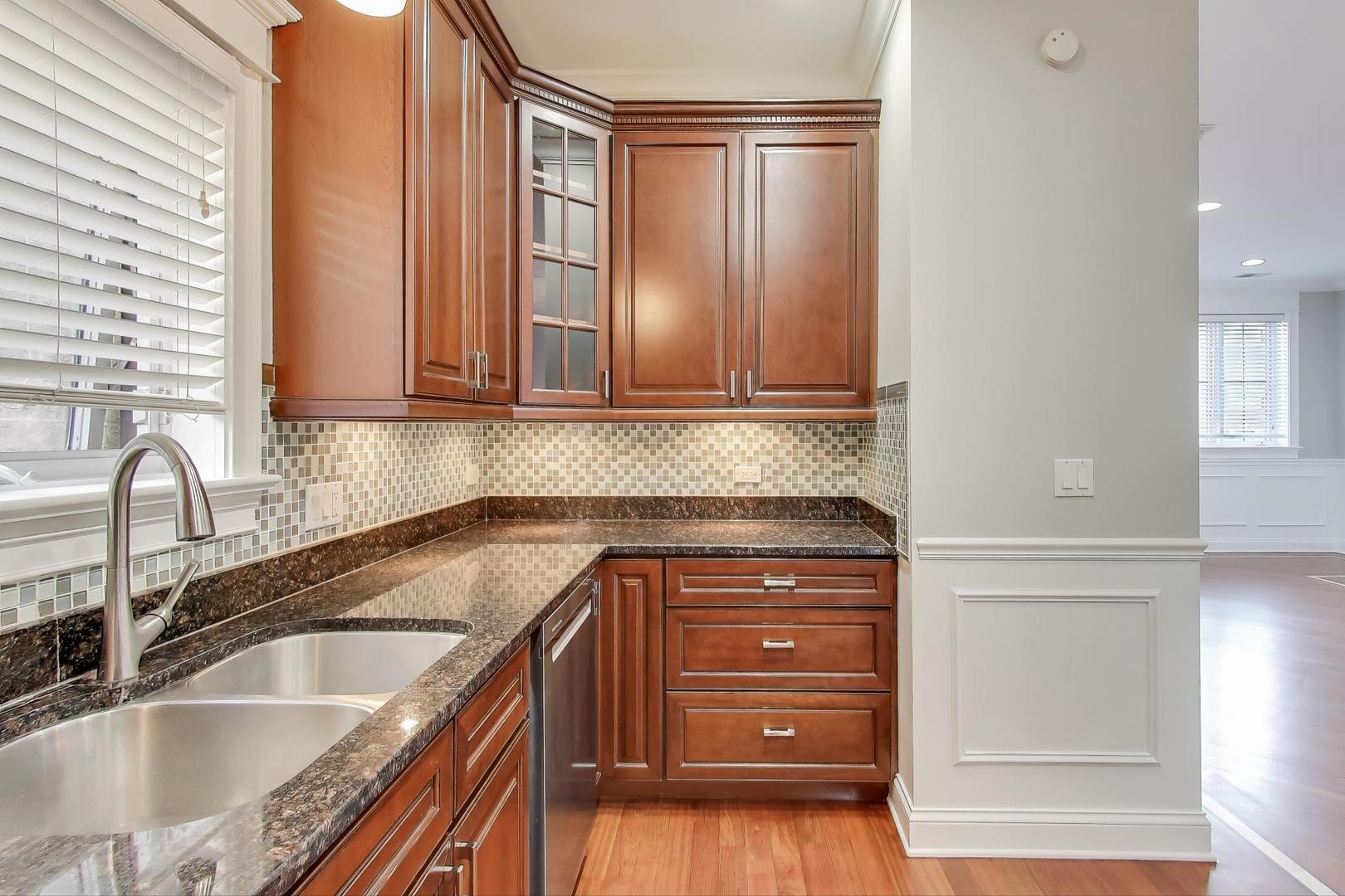 5058 North Kimball Avenue, Unit 4 Chicago, IL 60625 - Photo 9 of 26 a kitchen with granite countertop a sink and a cabinets