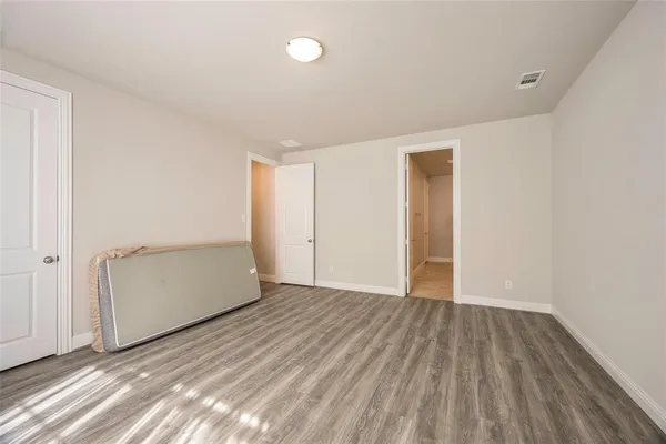 a view of an empty room and wooden floor
