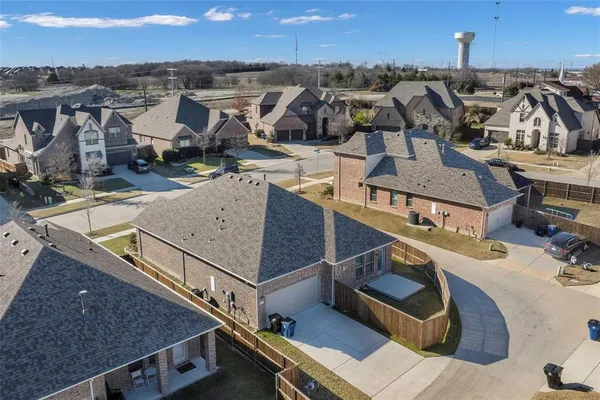 an aerial view of a house with a big yard