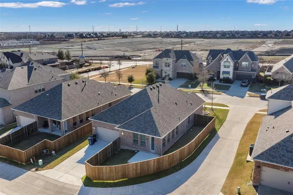 an aerial view of a house with a swimming pool and outdoor seating