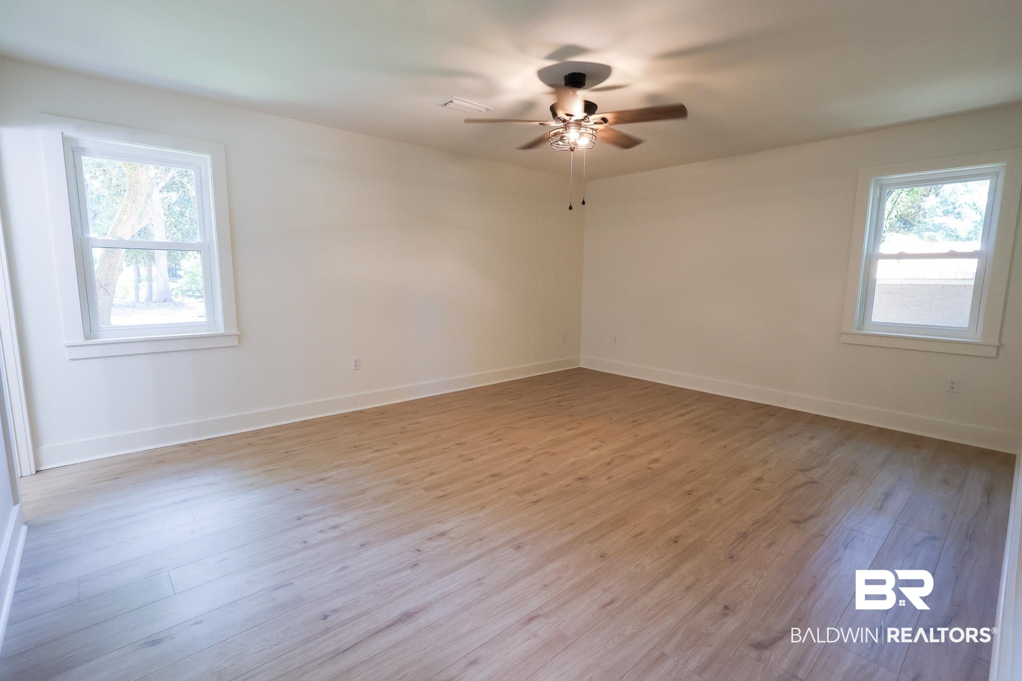 12190 Pecan Grove Street Magnolia Springs, AL 36555 - Photo 20 of 45 Spare room with a wealth of natural light, light wood-type flooring, and ceiling fan