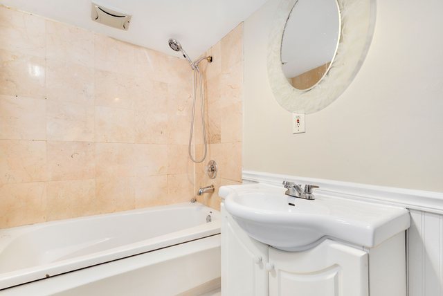 8458 South Constance Avenue Chicago, IL 60617 - Photo 16 of 23 a bathroom with a sink and a mirror