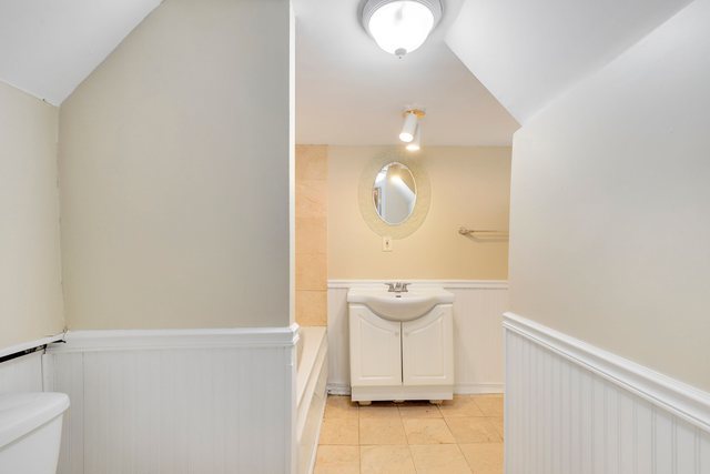 8458 South Constance Avenue Chicago, IL 60617 - Photo 17 of 23 a bathroom with a sink and mirror
