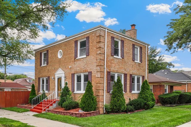 8458 South Constance Avenue Chicago, IL 60617 - Photo 2 of 23 a front view of a house with garden