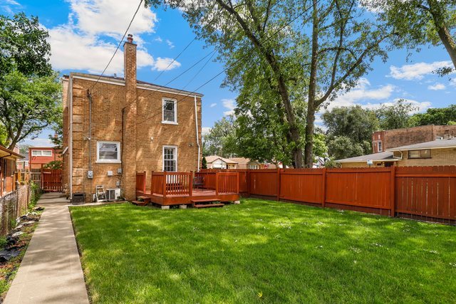 8458 South Constance Avenue Chicago, IL 60617 - Photo 21 of 23 a view of a house with a backyard