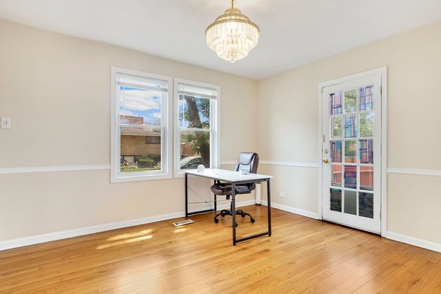 8458 South Constance Avenue Chicago, IL 60617 - Photo 4 of 23 a workspace with furniture window and wooden floor