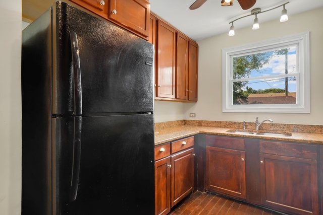 8458 South Constance Avenue Chicago, IL 60617 - Photo 8 of 23 a kitchen with a sink and a refrigerator