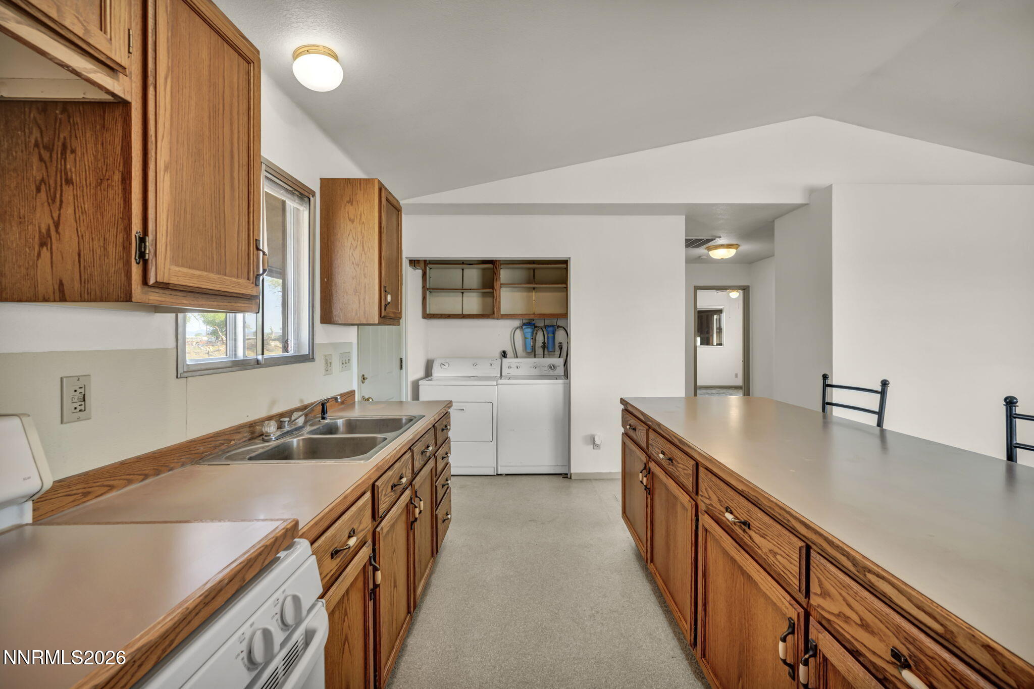 5250 Stillwater Road Fallon, NV 89406 - Photo 15 of 53 a kitchen with a sink stove and cabinets