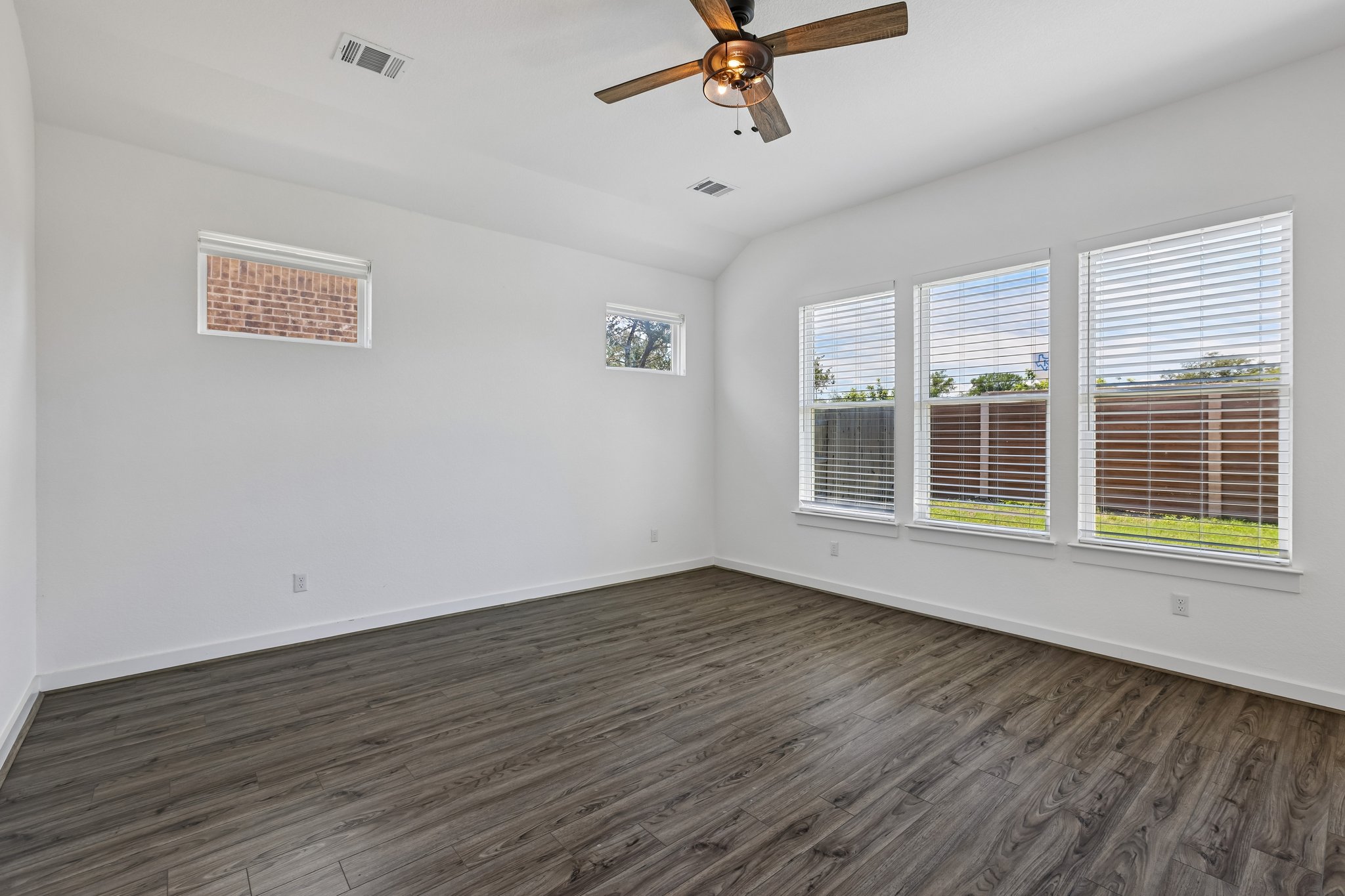 317 Independence Drive Kyle, TX 78640 - Photo 17 of 40 a view of an empty room with wooden floor and a window