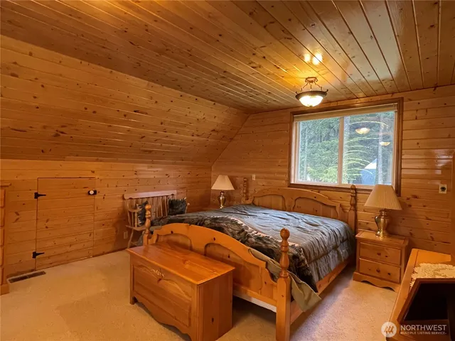 a bed sitting in a bedroom next to a window