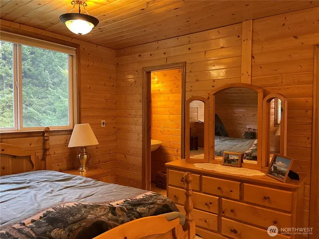 a bedroom with a bed and a dresser