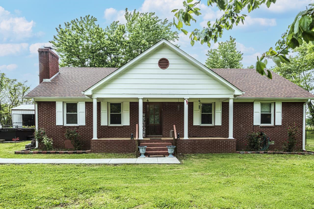 827 Sanford Road Covington, TN 38019 - Photo 1 of 25 a front view of a house with a yard